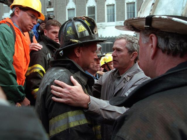 President George W. Bush embraces a firefighter at the site of the World Trade Center, September 14, 2001, during his visit to New York City. (P7371-06a)