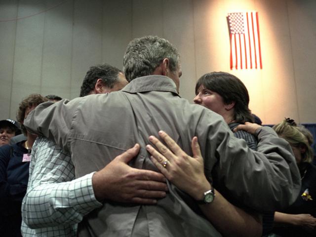 President George W. Bush consoles a family, September 14, 2001, during his trip to New York City. (P7385-12)