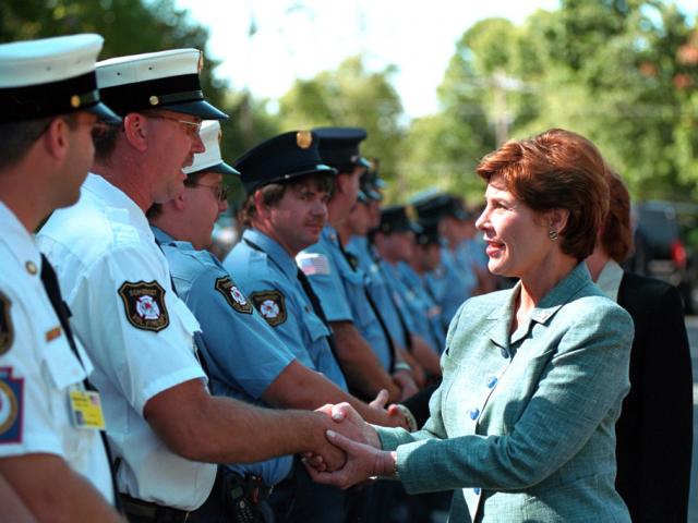 Mrs. Laura Bush greets firefighters and police, September 17, 2001, at a memorial service for victims of United Flight 93 at the Indian Lake Resort in Central City, Pennsylvania. (P7475-05a)