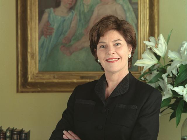 Mrs. Laura Bush poses in front of Mary Cassatt's painting,