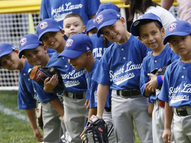 Players of the Jose M. Rodriguez Little League Angels look toward President George W. Bush.