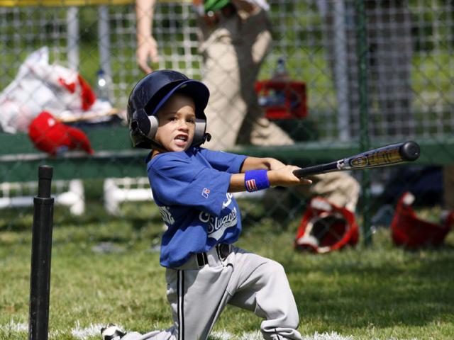 A player hits the ball during the season opener.