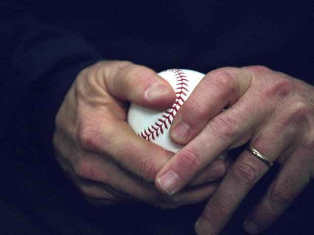 President George W. Bush holds a baseball, October 30, 2001, as he approaches the playing field at Yankee Stadium to throw out the ceremonial first pitch for Game Three of the World Series in New York City. (P9151-15)