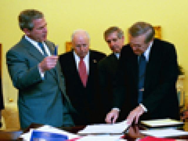 During his morning briefing, April 2, 2003, President George W. Bush reviews the progress of the war with members of the War Council. (P28531-23A)