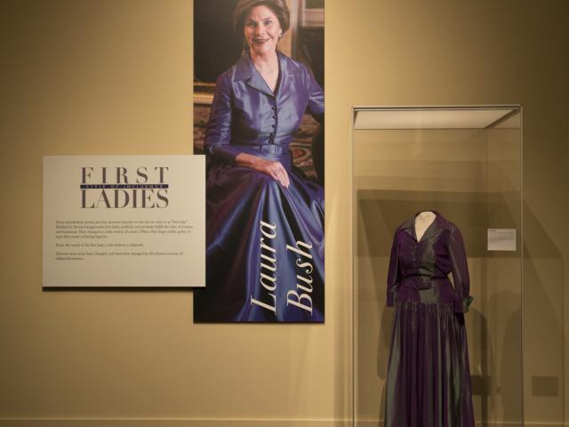 A picture and dress of First Lady Laura Bush included in the 2018 First Ladies exhibit at the George W Bush Library and Museum