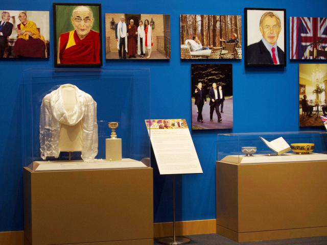 A picture of displays featuring the Dalai Lama and Prime Minister Tony Blair, from the 2014 exhibit The Art of Leadership: A President's Personal Diplomacy, at the George W Bush Library and Museum