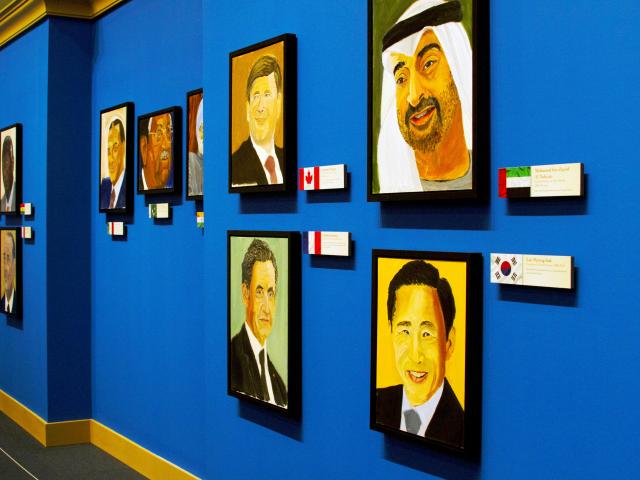 A picture of a wall of painted portraits, part of the 2014 exhibit The Art of Leadership: A President's Personal Diplomacy, at the George W Bush Library and Museum