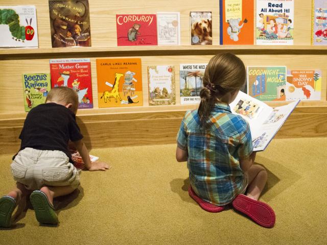 Two young children enjoying the reading area in the No Child Left Behind area of the George W Bush museum