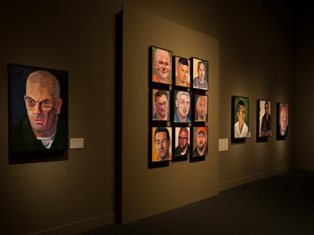 A photo of a wall of portraits painted by President George W Bush, part of the 2017 exhibit Portraits of Courage, at the George W Bush Library and Museum