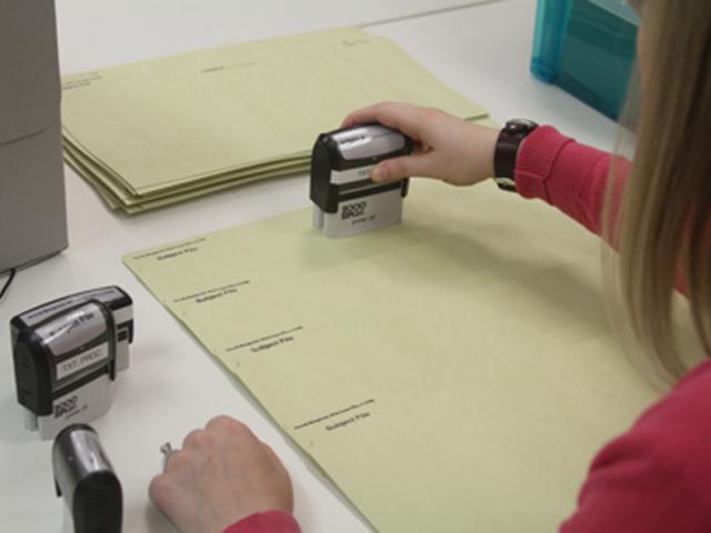 Archivist stamping documents