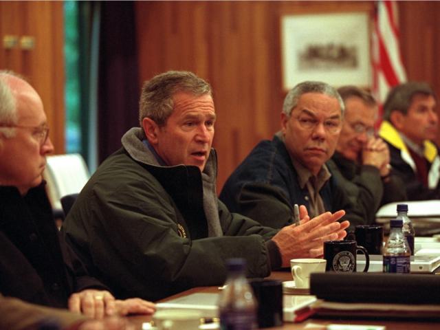 On September 15, 2001,  President George W. Bush confers with his National Security Council at Camp David in Thurmont, Maryland. Pictured from left are: Vice President Dick Cheney; Colin Powell, Secretary of State; Donald Rumsfeld, Secretary of Defense; and Paul Wolfowitz, Deputy Secretary of Defense.