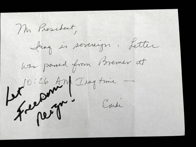 President George W. Bush wrote, "Let Freedom Reign" in response to a note passed to him by Dr. Condoleezza Rice while attending the opening session of a NATO summit in Istanbul, Turkey. (P41953-852)