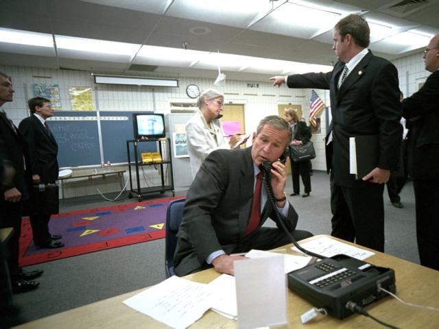 President George W. Bush and White House Staff watch news coverage of Flight 175 striking the South Tower of the World Trade Center at Emma E. Booker Elementary School in Sarasota, Florida, September 11, 2001.