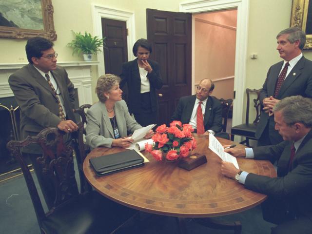 Working with his Senior Staff, President George W. Bush reviews a speech regarding the day's terrorist attacks that he will deliver to the Nation from the Oval Office, September 11, 2001.