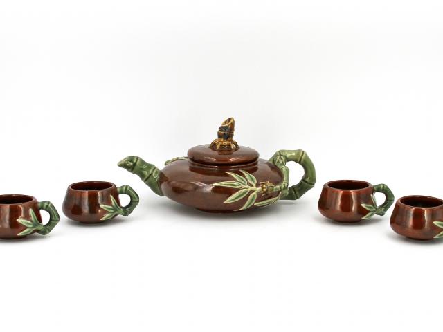 Brown glazed tea set, including a teapot with lid and four cups, all with green bamboo handles and designs. Presented by Donald Tsang Yam-Kuen, Chief Executive of the Hong Kong Special Administrative Region of the People’s Republic of China.