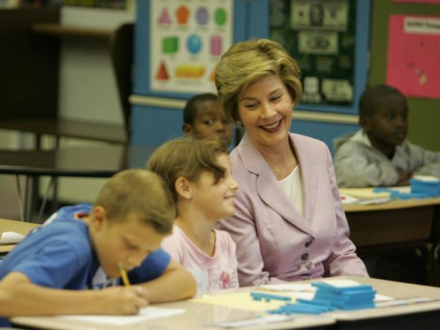 Mrs. Laura Bush sits with students