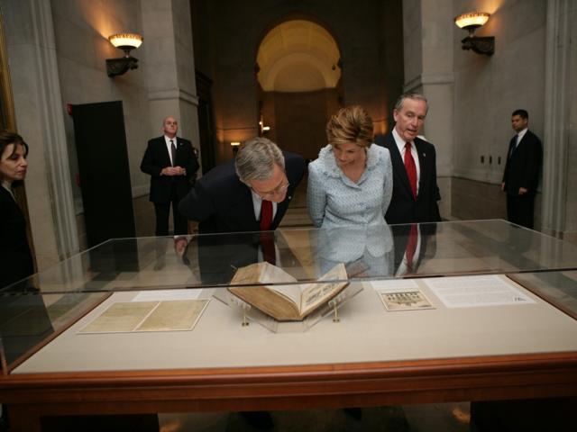 President George W. Bush and Mrs. Laura Bush view a document in a case at the National Archives