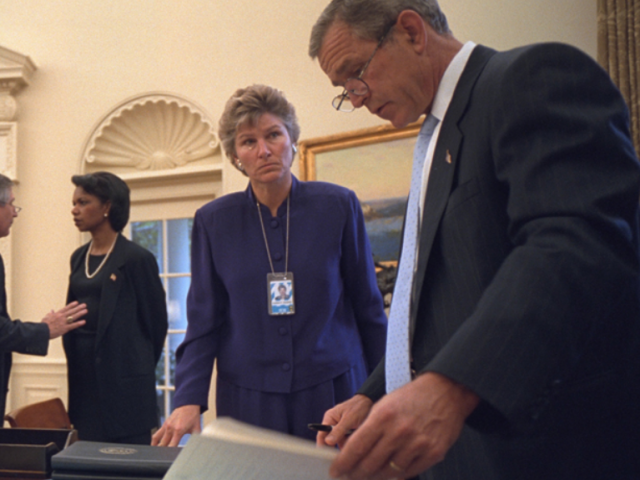 President Bush speaks to Karen Hughes in the Oval Office.
