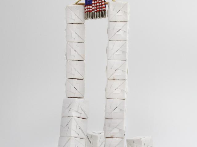 White folded paper blocks forming the World Trade Center twin towers by artist Mei-Kuei Chan Cruise. Originally displayed on the Blue Room Christmas tree in 2001.