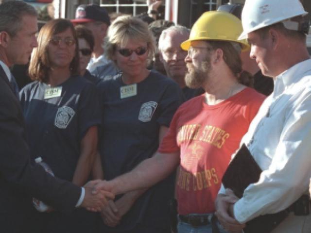 President George W. Bush shakes hands with construction workers rebuilding after Hurricane Katrina.