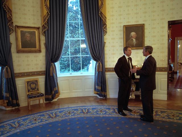President Bush speaks with Prime Minister Tony Blair in the Blue Room of the White House