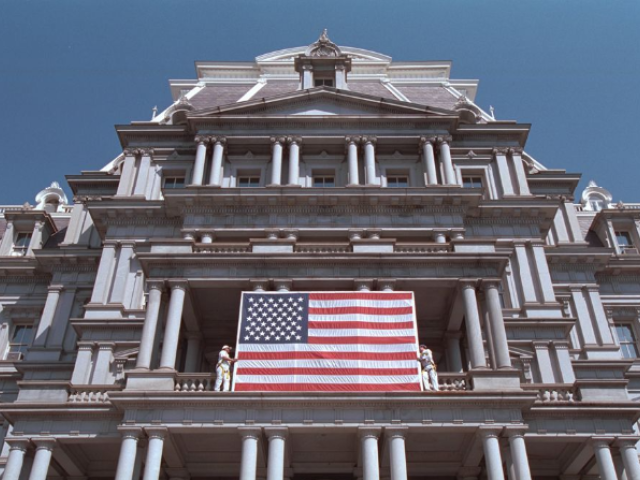 General Services Administration workers hang an American flag at the Eisenhower Executive Office Building, September 13, 2001.