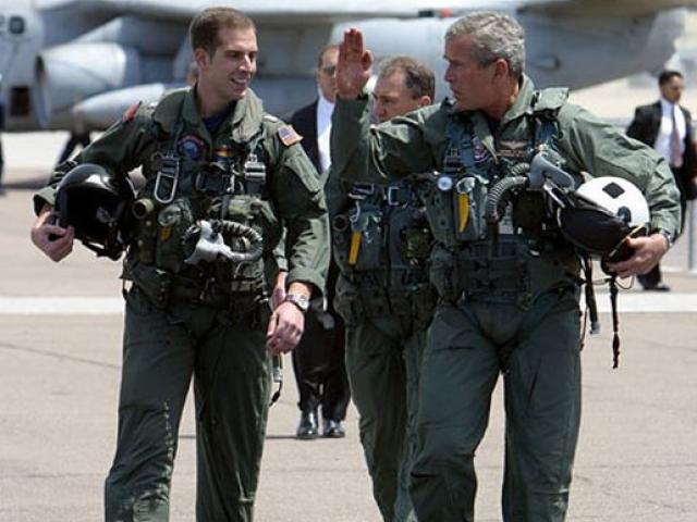  President George W. Bush walks across the tarmac with NFO Lt. Ryan Phillips to Navy One, an S-3B Viking jet, at Naval Air Station North Island in San Diego, May 1, 2003.