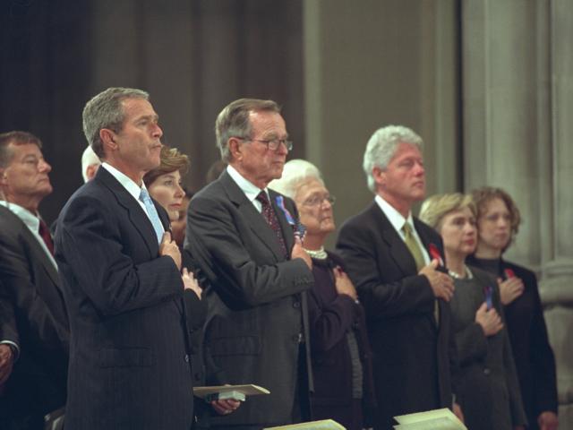 President George W. Bush, Mrs. Laura Bush, Former President George H. W. Bush, Mrs. Barbara Bush, Former President Bill Clinton, Sen. Hillary Rodham Clinton, and Chelsea Clinton, stand with hands over hearts for the Pledge of Allegiance during the National Day of Prayer and Remembrance service at the National Cathedral in Washington, DC.