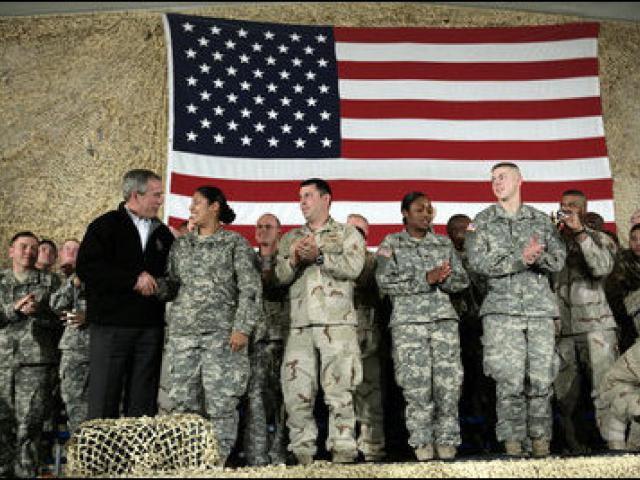 President George W. Bush meets and thanks a group of U.S. and Coalition troops, March 1, 2006, during a visit to Bagram Air Base in Afghanistan, where President Bush thanked the troops for their service in defense of freedom.