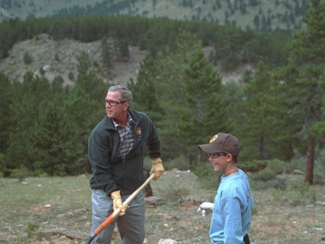 President George W. Bush helps build a trail at Rocky Mountain National Park in Estes, Colorado, August 14, 2001.