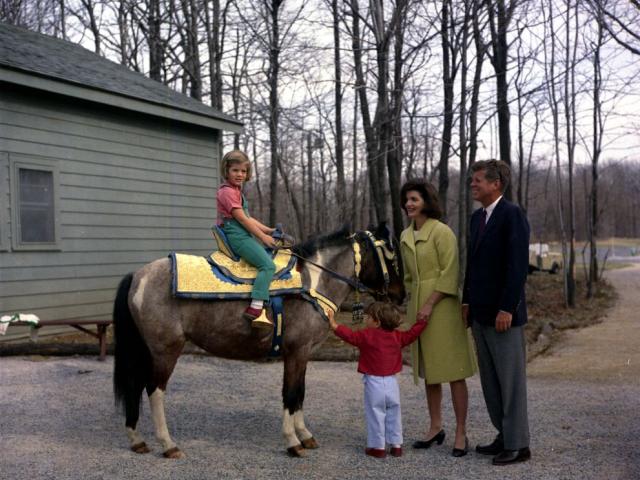 President John F. Kennedy and family watch Caroline Kennedy riding Macaroni at Camp David, Maryland, March 31, 1963. Robert Knudsen, White House Photographs. John F. Kennedy Presidential Library and Museum, Boston. KN-C27672.