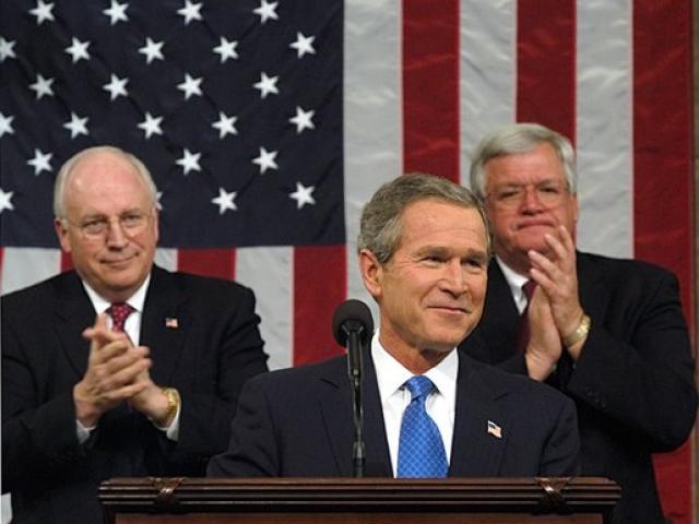 President George W. Bush reacts to applause while delivering the State of the Union address at the U.S. Capitol, January 28, 2003. Also pictured are Vice President Dick Cheney, left, and Speaker of the House Dennis Hastert.