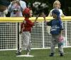 Two opposing players high-five on the field
