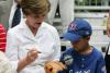 Mrs. Laura W. Bush autographs a glove for a Dolcom Little League Indian.