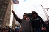 Standing upon the ashes of the terrorist attacks upon the World Trade Center with retired firefighter Bob Beckwith from Ladder 117, President George W. Bush waves an American flag, September 14, 2001, after addressing recovery workers in New York City. (P7376-22)