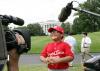 A player with the Cramer Hill Little League Red Sox of Camden, New Jersey, is the center of media attention.
