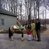President John F. Kennedy and family watch Caroline Kennedy riding Macaroni at Camp David, Maryland, March 31, 1963. Robert Knudsen, White House Photographs. John F. Kennedy Presidential Library and Museum, Boston. KN-C27672.