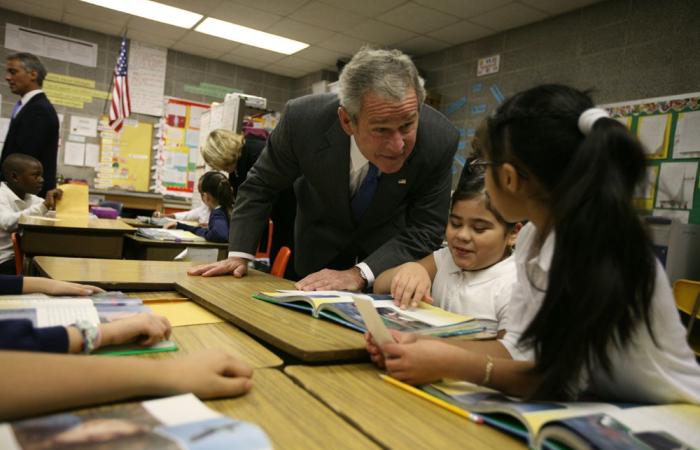 President Bush speaks with students at their desks