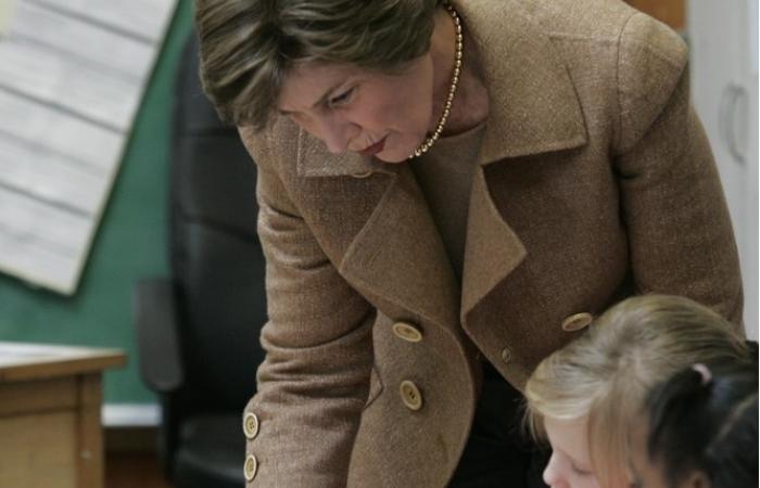 Mrs. Laura Bush works with students at their desks