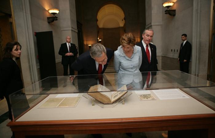 President George W. Bush and Mrs. Laura Bush view a document in a case at the National Archives