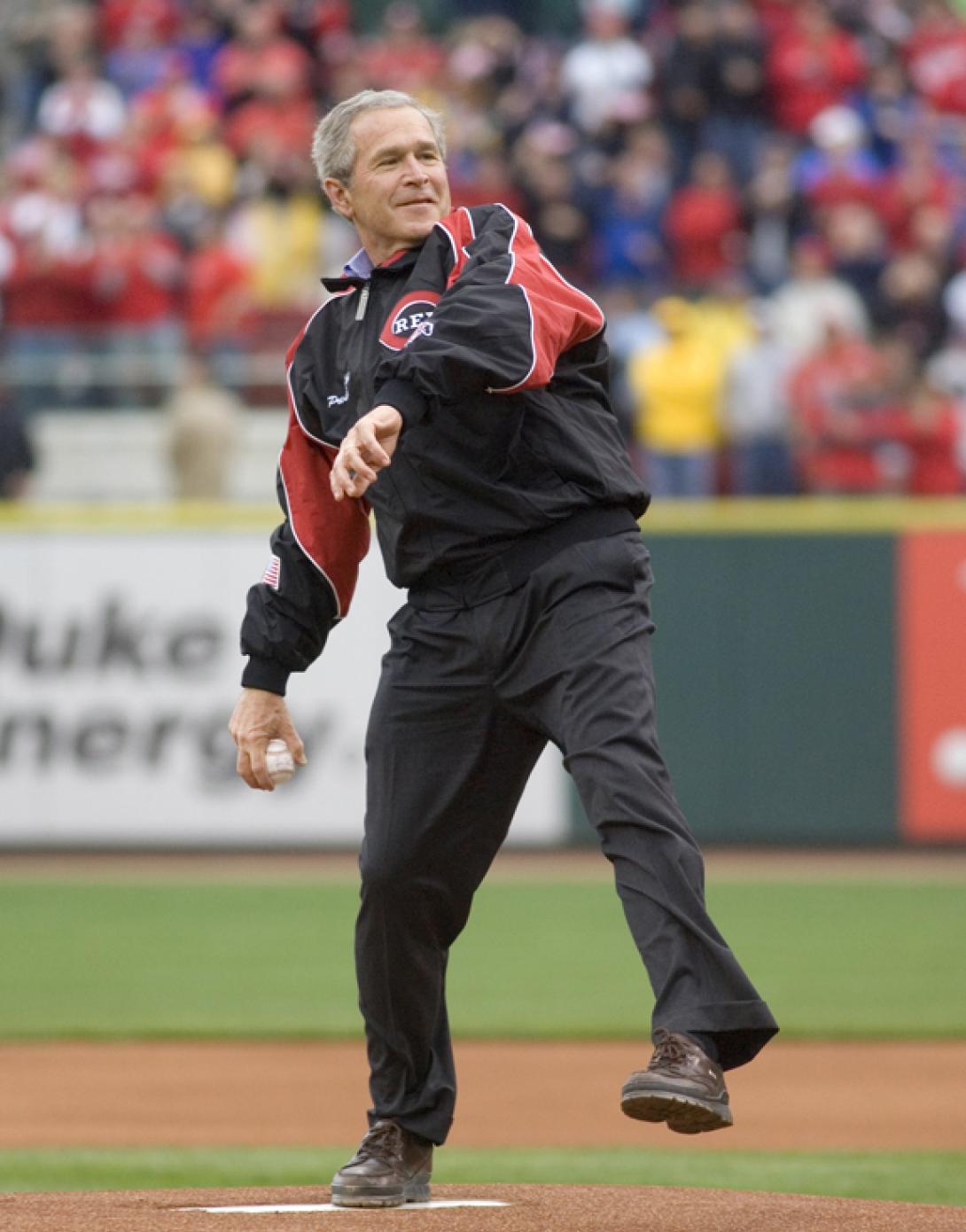President George W. Bush winds up to throw the first pitch of the 2006 baseball season during the opening game between the Cincinnati Reds and the Chicago Cubs, April 3, 2006, in Cincinnati.  (P040306ED-0535A)