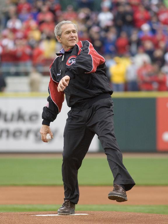 President George W. Bush winds up to throw the first pitch of the 2006 baseball season during the opening game between the Cincinnati Reds and the Chicago Cubs, April 3, 2006, in Cincinnati.  (P040306ED-0535A)