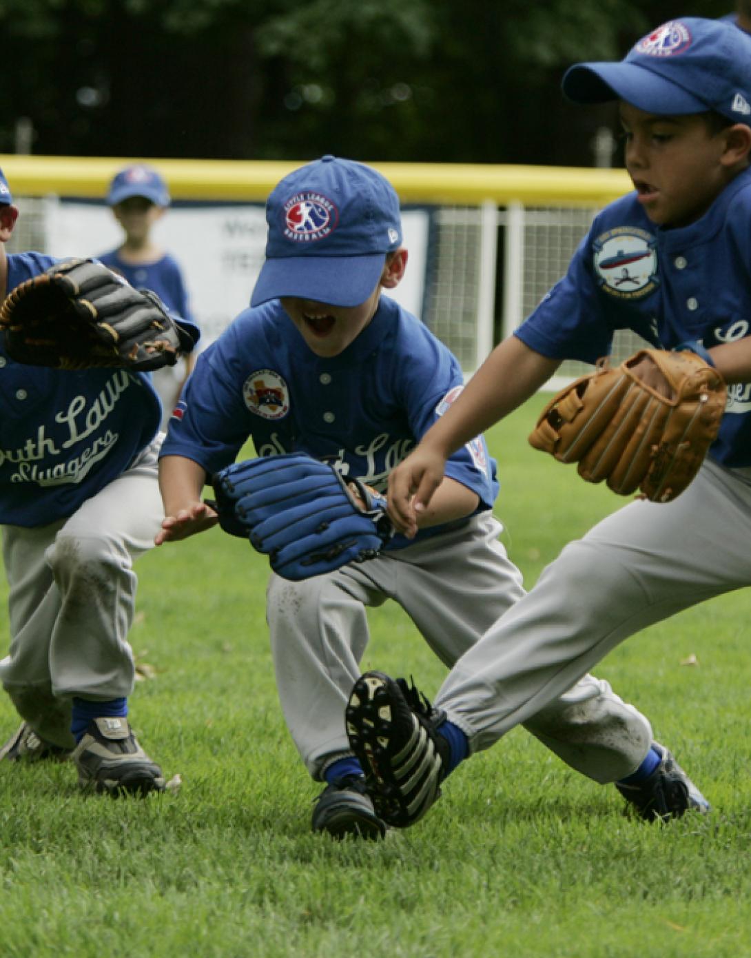 Three little leaguers dive for the ball on the South Lawn of the White House
