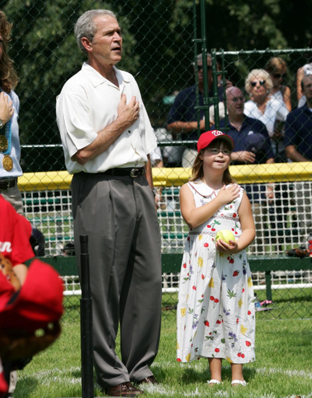 President George W. Bush is joined for the singing of the national anthem by Meredith Cripe.