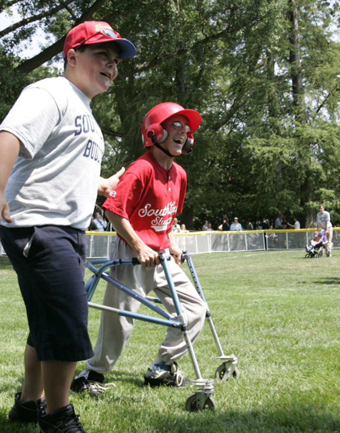 A player is accompanied to first base by a South Lawn buddy.
