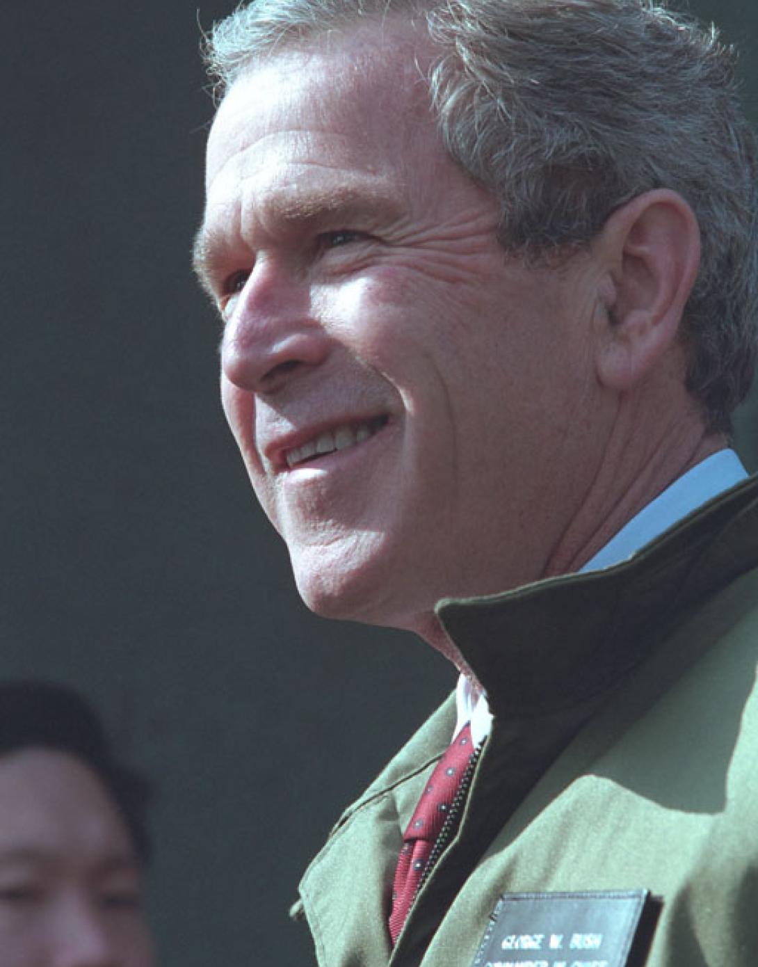 President George W. Bush stands with troops, February 20, 2002, at the U.S. Army Garrison Landing Zone during his trip to Yongsan, Republic of Korea. (P13629-13A)