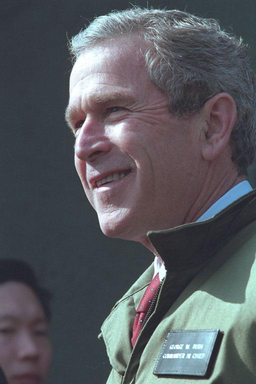 President George W. Bush stands with troops, February 20, 2002, at the U.S. Army Garrison Landing Zone during his trip to Yongsan, Republic of Korea. (P13629-13A)