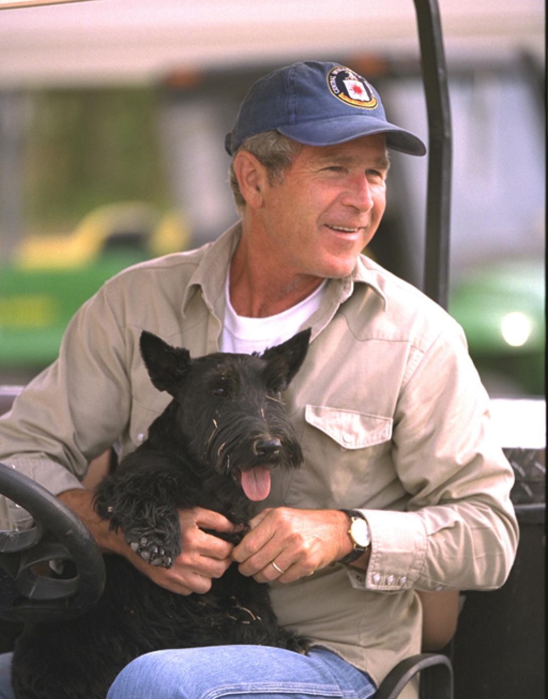 President George W. Bush sits with Barney, August 27, 2002, at Prairie Chapel Ranch in Crawford, Texas. (P20871-12A)