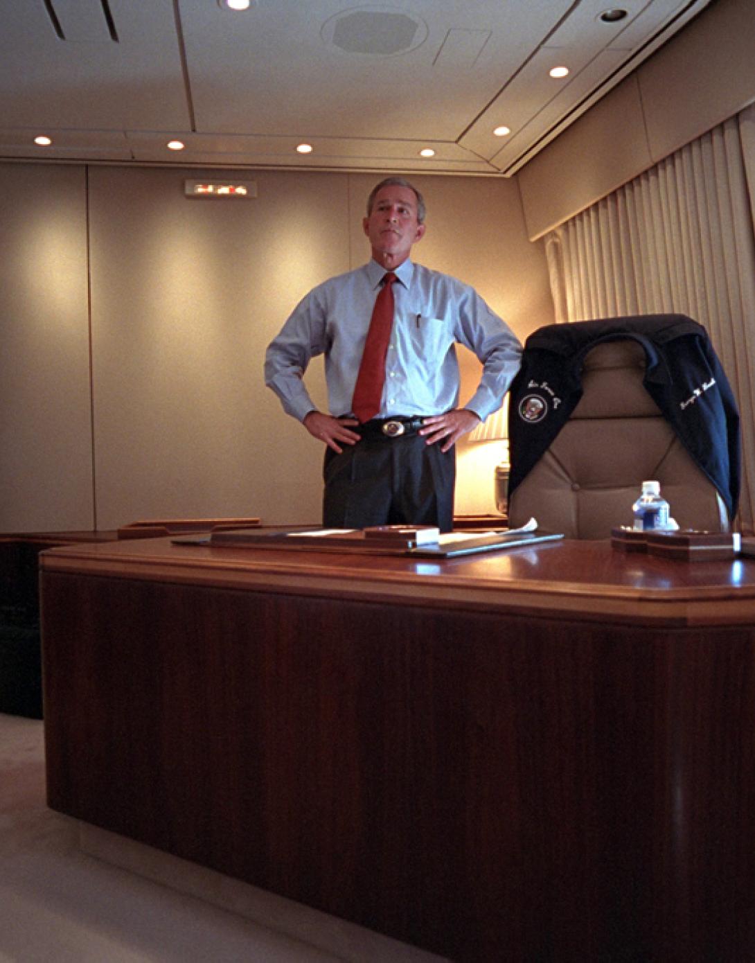President George W. Bush watches television coverage of the terrorist attacks on the World Trade Center, September 11, 2001, from his office on Air Force One. (P7067-19)