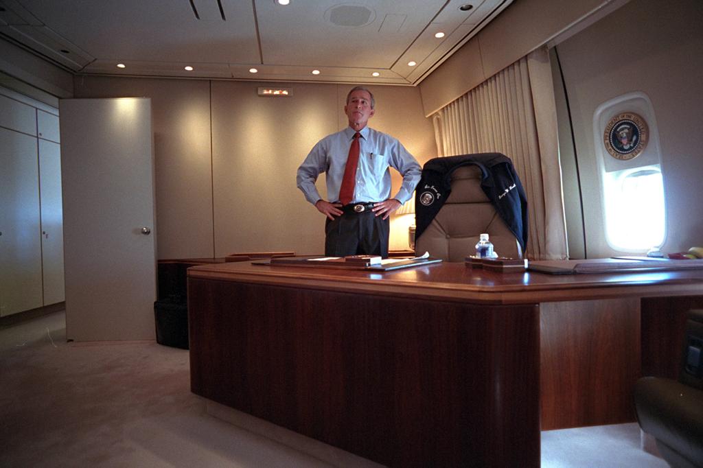 President George W. Bush watches television coverage of the terrorist attacks on the World Trade Center, September 11, 2001, from his office on Air Force One. (P7067-19)